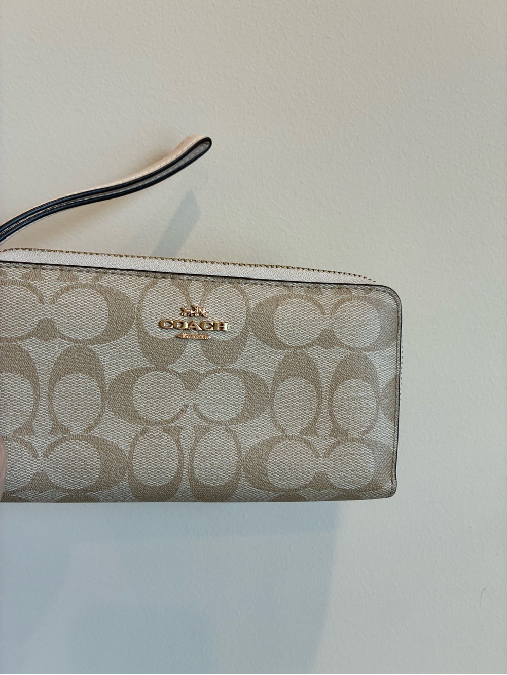 Coach Signature Long Zip Around Wallet in Light khaki/chalk canvas.